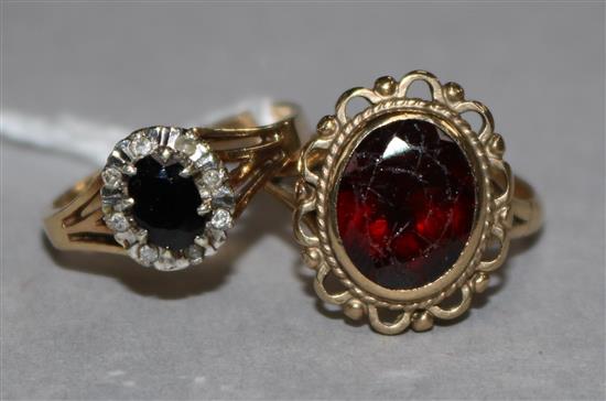 A sapphire and diamond oval cluster ring, 9ct gold setting and a 9ct gold garnet-set dress ring.